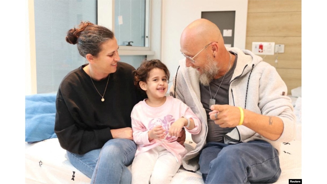 Abigail Edan, who was released after being taken hostage by the Palestinian militant group Hamas, talks with her aunt Liron and uncle Zuli in this handout picture released by Schneider Children's Medical Center of Israel on November 27, 2023.