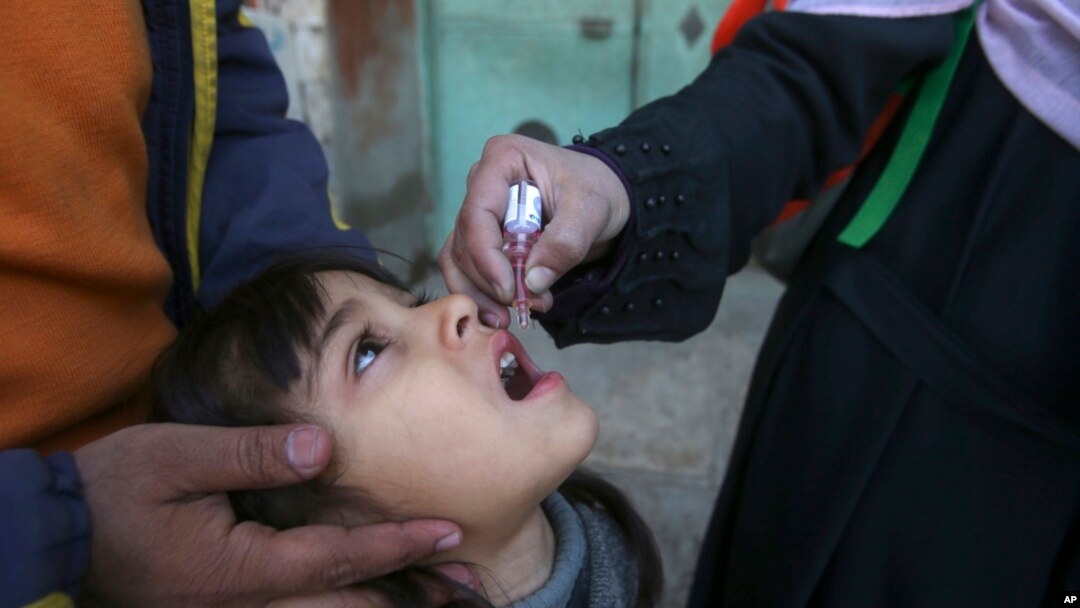 FILE - A health worker administers a polio vaccine to a child in Peshawar, Pakistan, March 4, 2024. 