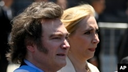 Javier Milei, left, and his sister, Karina, arrive at the government house in Buenos Aires, Dec. 10, 2023, after he was sworn in as Argentina's president. Two days later, Milei's administration announced economic measures aimed at tackling the country's severe crisis.