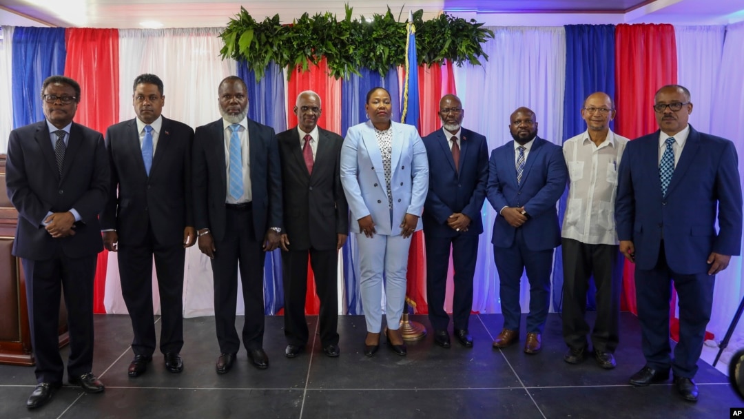 FILE - Haiti's transitional presidential council members pose for a group photo in Port-au-Prince, Haiti, April 30, 2024. Louis Gerald Gilles is pictured on the right. Smith Augustin is third from right and Emmanuel Vertilaire is fourth from right. 