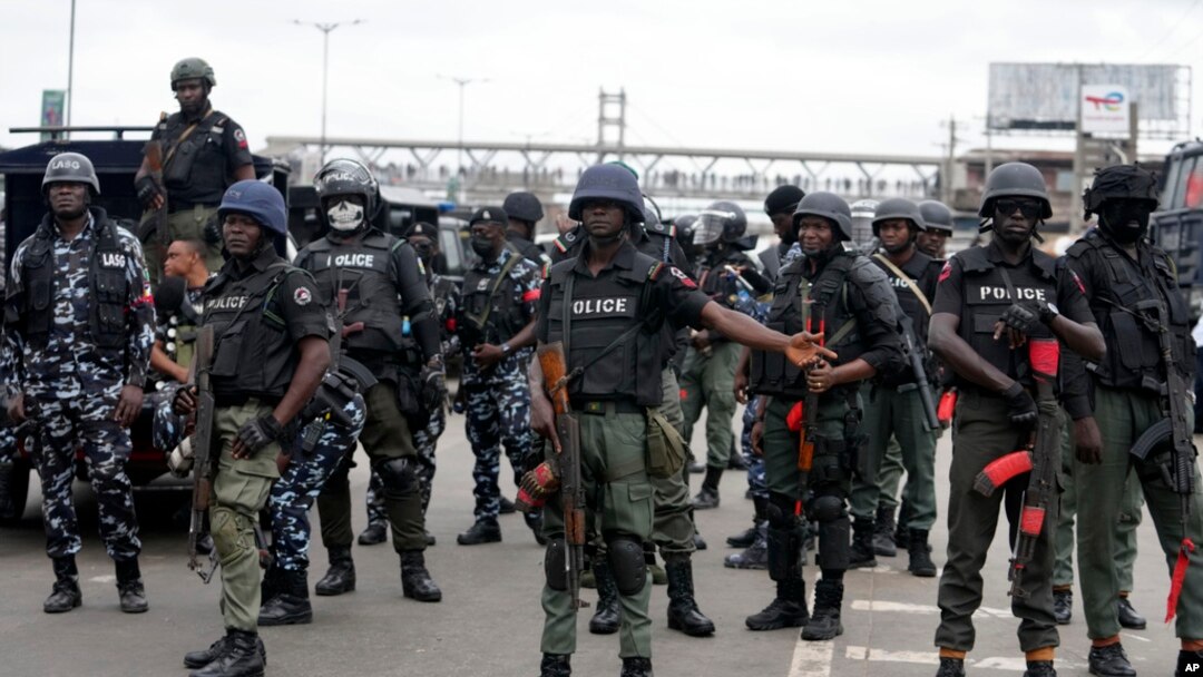 Police officers stand guard during a protest in Lagos, Nigeria, Aug. 1, 2024.