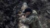 A Ukrainian serviceman stands near a tank, as Russia's attack on Ukraine continues, near the front line city of Bakhmut, Ukraine, April 10, 2023.