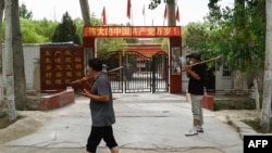 FILE - This picture taken July 17, 2023, shows the facade of the headquarters of the Chinese Communist Party, in Aral Mehelle village, outside Yarkant in northwestern China's Xinjiang region. 