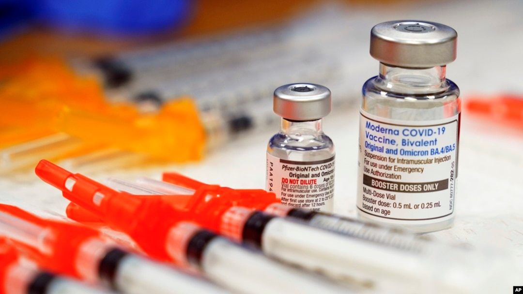 FILE - Pfizer, left, and Moderna bivalent COVID-19 vaccines are readied for use at a clinic, Nov. 17, 2022, in Richmond, Va. 