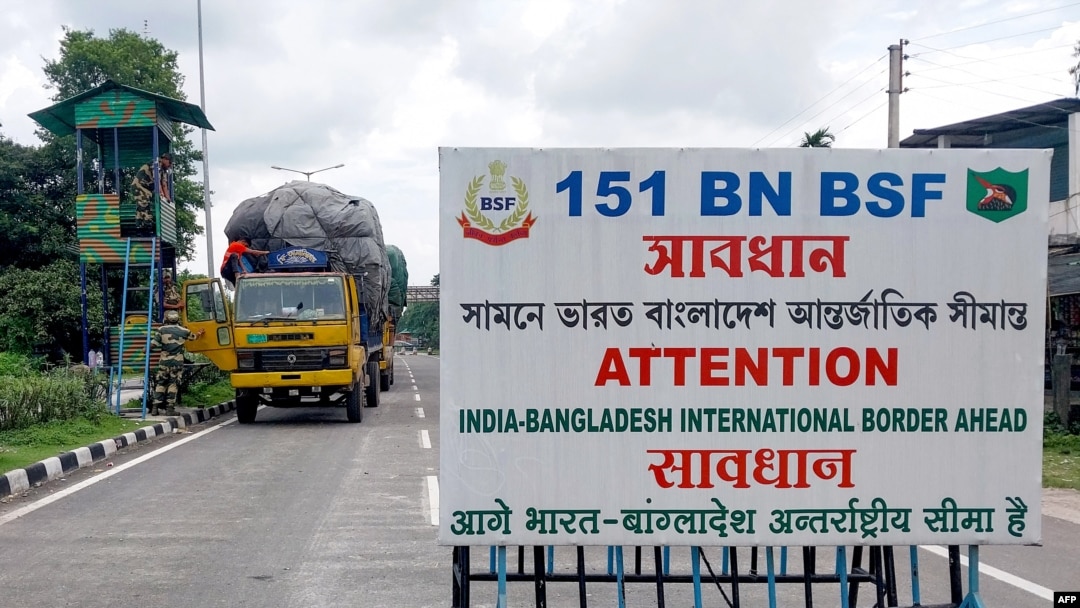 FILE - Border Security Force (BSF) personnel inspect a truck carrying supplies to Bangladesh at the India-Bangladesh border in Fulbari on the outskirts of Siliguri, Aug. 7, 2024