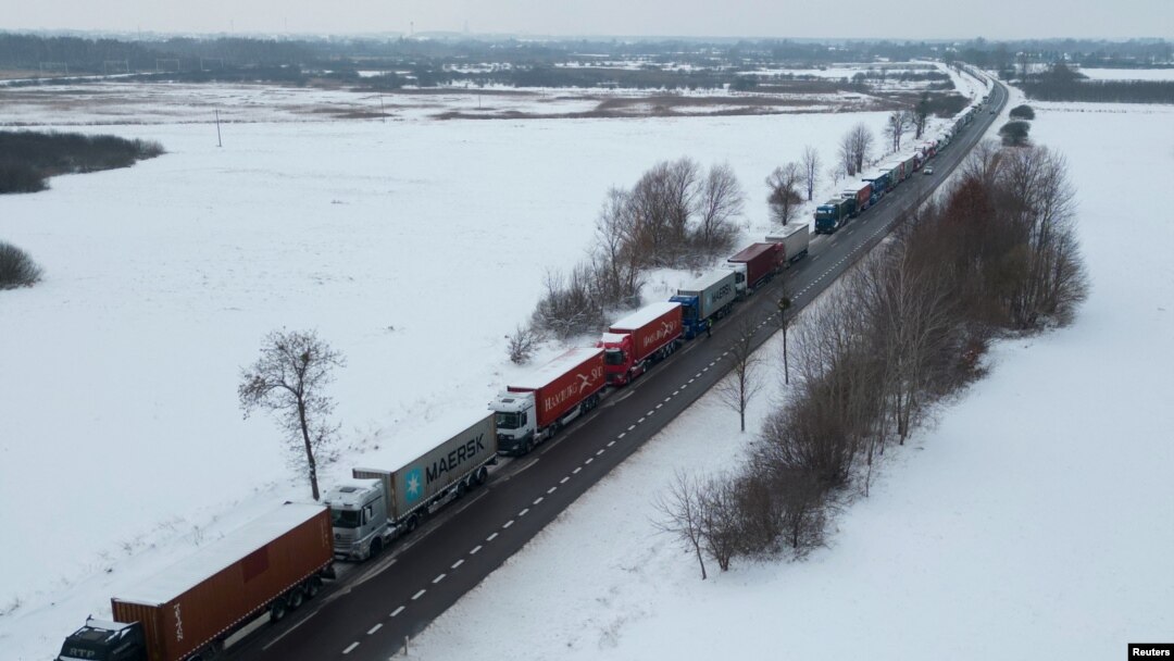FILE - Trucks line up in a long queue to cross the Polish-Ukrainian border at the Dorohusk-Jagodzin crossing, in Brzezno, Poland, Dec. 4, 2023. 