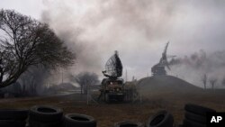 Smoke rise from an air defence base in the aftermath of an apparent Russian strike in Mariupol, Ukraine, Feb. 24, 2022.