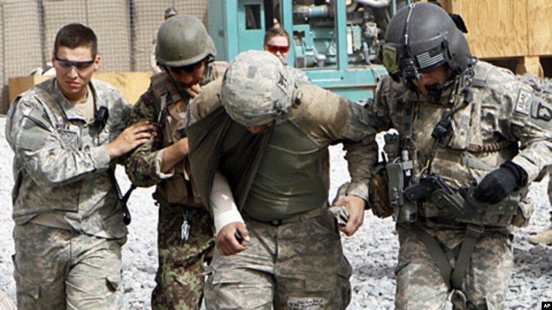 FILE - An Afghan soldier and a U.S. soldier were injured by a roadside bomb blast, Sept. 18, 2010. Such blasts can cause to traumatic brain injuries and internal bleeding. Researchers are looking at ways to better treat such injuries.
