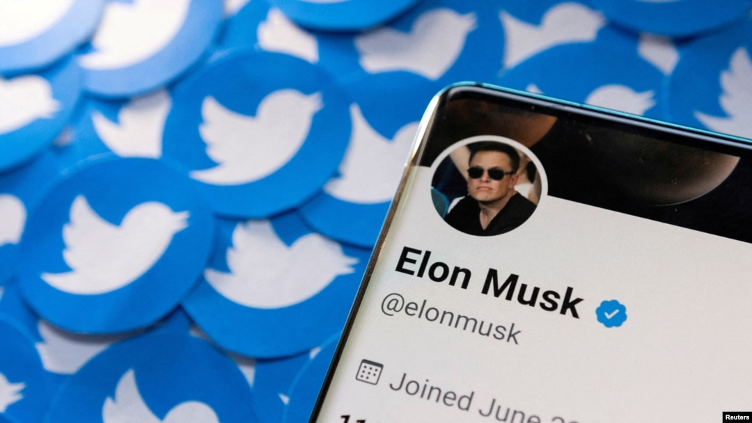 FILE: Elon Musk's Twitter profile is seen on a smartphone placed on printed Twitter logos in this picture illustration taken April 28, 2022.