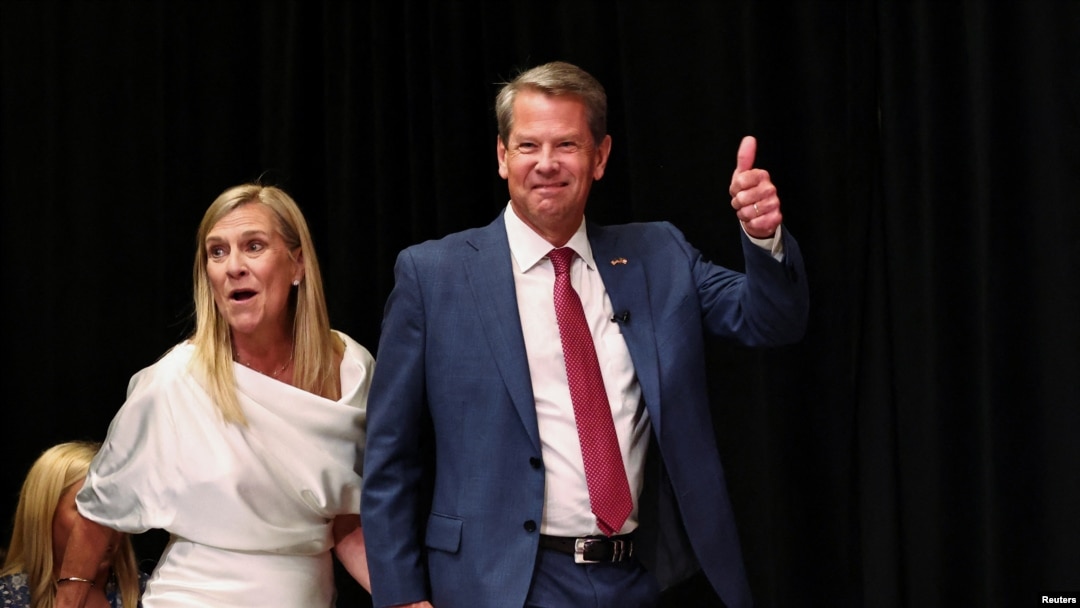 Governor Brian Kemp walks on stage with his wife Marty Kemp to speak after winning the Republican primary during his primary election watch party in Atlanta, Georgia, May 24, 2022. 