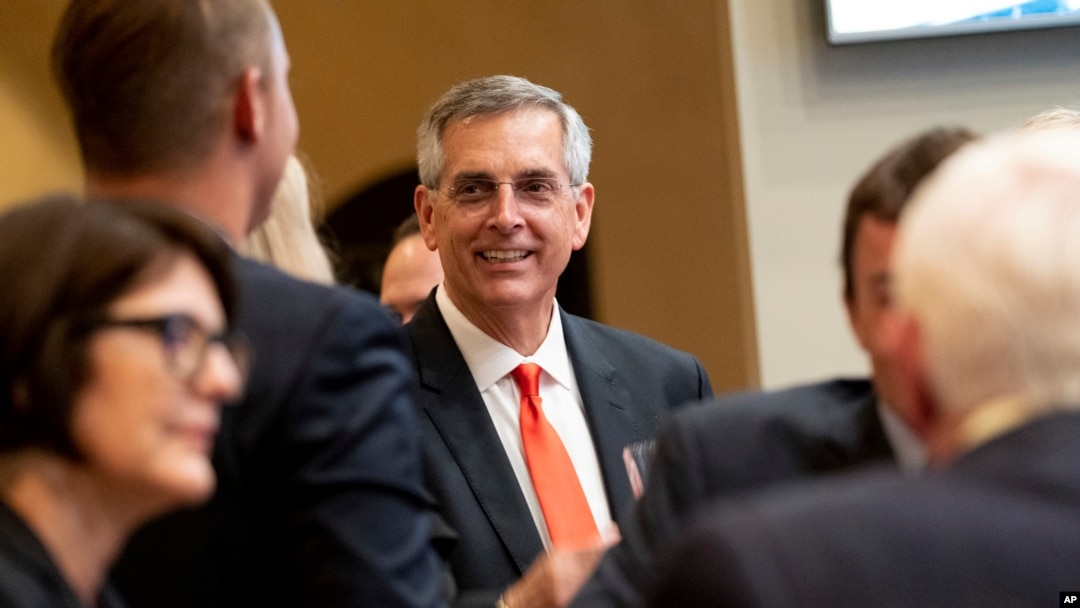 Incumbent Georgia Secretary of State Brad Raffensperger talks with supporters during an election night party Tuesday evening, May 24, 2022, at a small restaurant in Peachtree Corners, Ga.