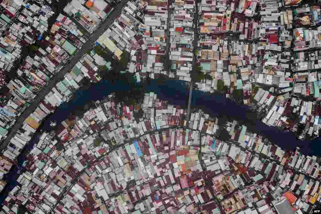 Houses are seen along the Xuyen Tam canal in Ho Chi Minh City, Vietnam. There are about 20,000 remaining households on Ho Chi Minh City&#39;s serpentine waterways slated to be demolished by 2020 as part of the city&#39;s massive renewal project. The city promises to replace some of the polluted canal banks with Parisian-style riverside promenades, paved roads, modern shops and buildings.