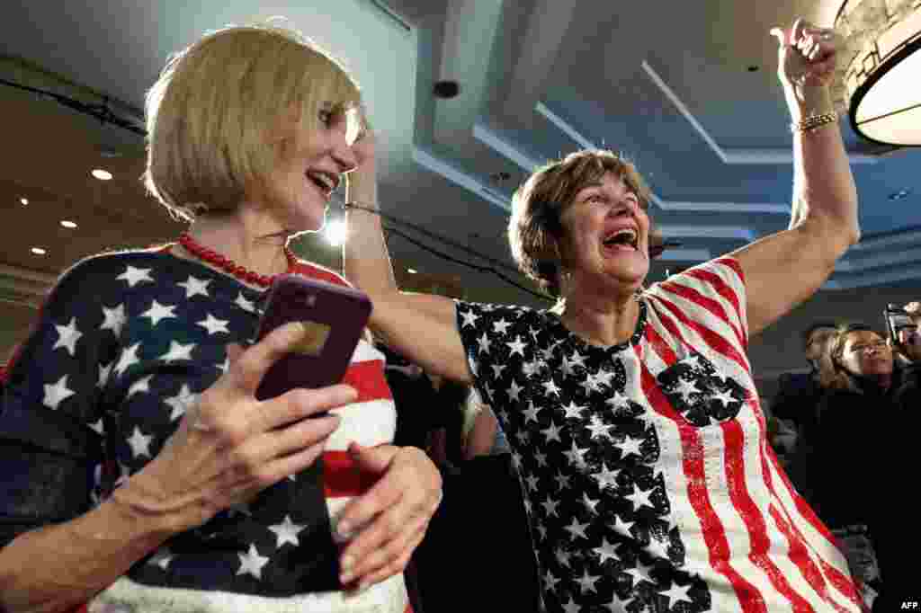 Karen Magnuson (L) and Kay Shaw celebrate after the announcement of the victory of Jason Crow, Democratic candidate for Colorado&#39;s 6th congressional District, during the Colorado Democrats watch party in Denver, Colorado, Nov. 6, 2018.