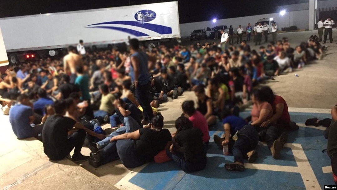 Migrants are pictured outside an abandoned truck trailer where Mexican authorities found 343 migrants from Central America, including 103 unaccompanied minors mostly from Guatemala inside in the eastern state of Veracruz, Mexico March 5, 2023. 