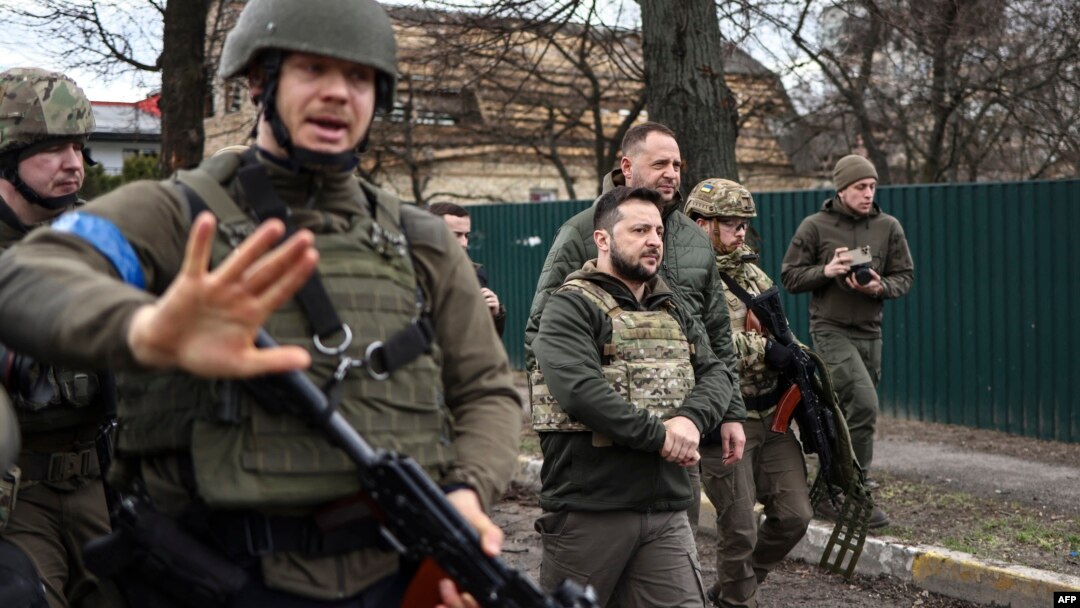 Ukrainian President Volodymyr Zelenskyy (center) walks in the town of Bucha, just northwest of Ukraine's capital, Kyiv, on April 4, 2022.