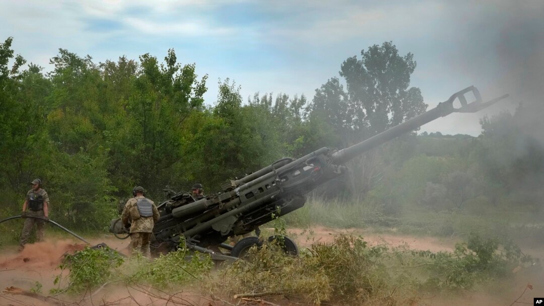 FILE - Ukrainian soldiers fire at Russian positions from a U.S.-supplied M777 howitzer in Ukraine's eastern Donetsk region, June 18, 2022. The U.S. has committed more than $60 billion — including more than $43 billion in military aid — to Ukraine since Russia invaded Ukraine.  