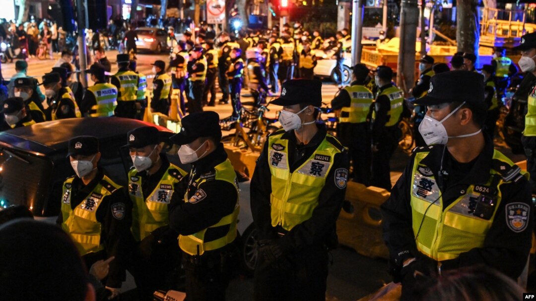 Police officers block Wulumuqi street, named for Urumqi in Mandarin, in Shanghai on Nov. 27, 2022, in the area where protests against China's zero-COVID policy took place the night before following a deadly fire in Urumqi.