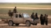 Members of Syrian Democratic Forces (SDF) stand together near Baghouz, Deir el-Zour province, Syria, Feb. 11, 2019. 