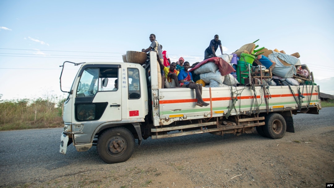 FILE - Displaced families from the community of Impire in the Cabo Delgado province are seen traveling on June 14, 2022, on a flatbed truck as they flee armed insurgents who attacked their community two days earlier. 
