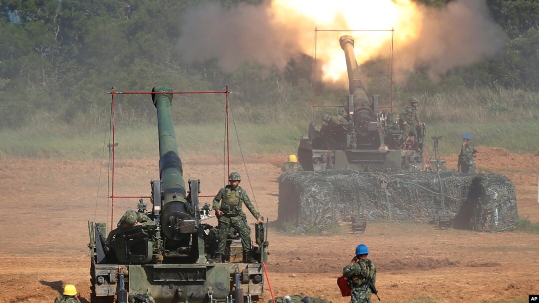 FILE - Taiwan's military fire artillery from self-propelled Howitzers during the annual Han Kuang exercises in Hsinchu, northeastern Taiwan, Sept. 10, 2015. 