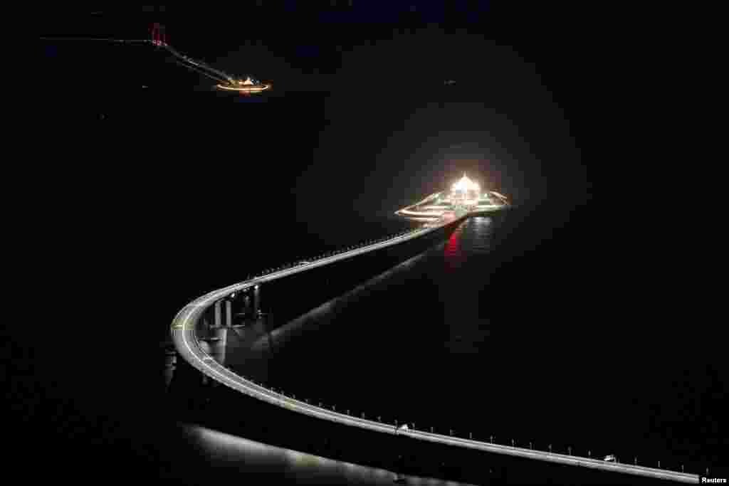 An evening view of the Hong Kong-Zhuhai-Macau bridge and its entrances to a cross sea tunnel, off Lantau island in Hong Kong, China, Oct. 21, 2018, before its opening ceremony on Oct. 23.