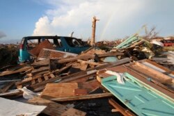 A rainbow rises over the extensive damage and destruction in the aftermath of Hurricane Dorian in The Mudd, Great Abaco, Bahamas, Thursday, Sept. 5, 2019. The Mudd was built by thousands of Haitian migrants over decades. It was razed in a matter of…