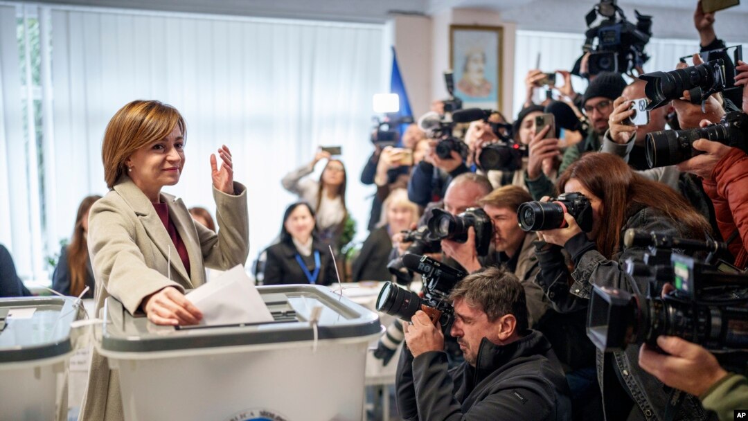 Moldova's President Maia Sandu prepares to cast her vote, in Chisinau, Moldova, Oct. 20, 2024, during a presidential election and a referendum on whether to enshrine in the Constitution the country's path to European Union membership.