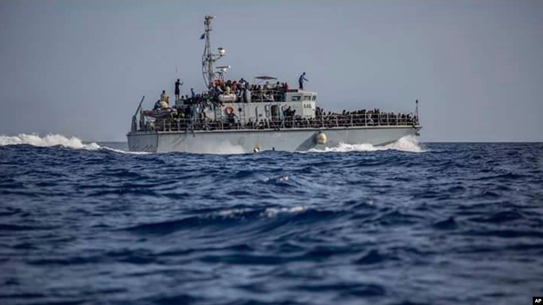 FILE - A photo released by the Libyan Coast Guard shows a ship with migrants off the coast of Libya, June 24, 2018.