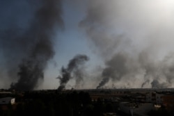In this photo taken from the Turkish side of the border between Turkey and Syria, in Akcakale, Sanliurfa province, southeastern Turkey, smoke billows from targets inside Syria during bombardment by Turkish forces, Oct. 10, 2019.