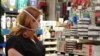 Customer Susan Buenaventura checks out painting supplies at Village Hardware in Alexandria, Virginia. (D. Block/VOA)
