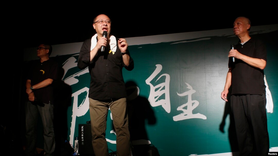 FILE - (L-R) Founders of the Occupy Central civil disobedience movement, academic Chan Kin-man, academic Benny Tai and Reverend Chu Yiu-ming, attend a rally, attended by thousands, in front of the government headquarters in Hong Kong, Sept. 27, 2014. 