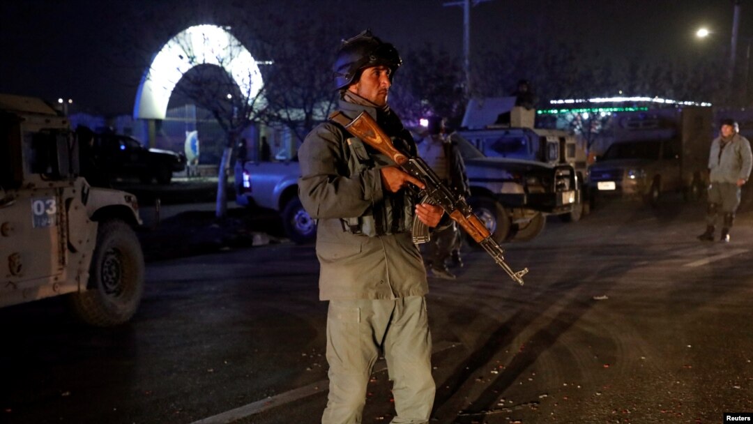 FILE - An Afghan police officer keeps watch at the site of a bomb attack, suspected to be the work of Islamic State's Afghan branch, in Kabul, Afghanistan, Nov. 20, 2018. 