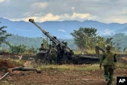 FILE - Members of an ethnic armed forces group, one of the three militias known as the Three Brotherhood Alliance, check weapons the group said it seized from Myanmar's army outpost in Hsenwi, Myanmar, on Nov. 24, 2023. (Kokang online media via AP)
