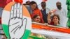 Congress party General Secretary and eastern Uttar Pradesh state in-charge Priyanka Gandhi Vadra, right, waves to party workers as she undertakes a steamer ride in the River Ganges from Manaiya, 25 kilometers (15.6 miles) from Prayagraj, India, March 18, 2019.
