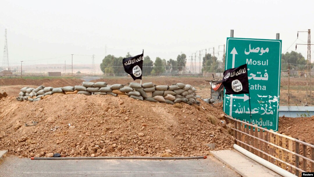 Islamic State flags flutter on the Mullah Abdullah bridge in southern Kirkuk, Iraq, Sept. 29, 2014.