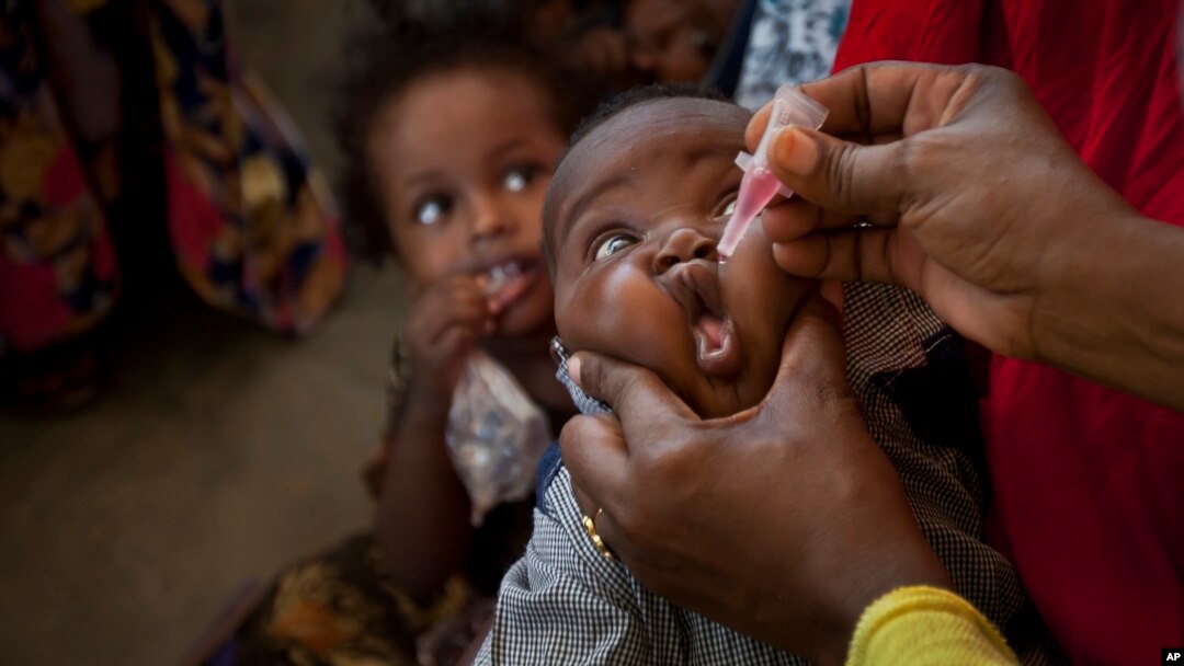 FILE - A Somali baby receives a polio vaccine at the Medina Maternal Child Health center in Mogadishu, Somalia, April 24, 2013. 