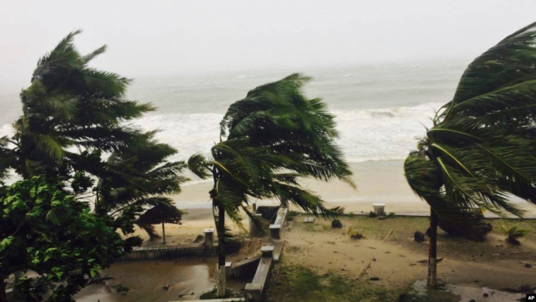 Trees are lashed by strong winds in Sambava, Madagascar, March 7, 2017 as heavy rains and strong winds from a cyclone hit northeast Madagascar, raising concerns about flooding and landslides. 