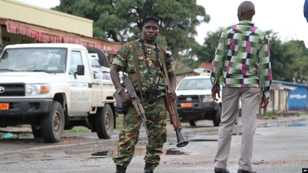 A Burundian soldier with his gun and rocket launcher guard a deserted street in Bujumbura, Burundi, Nov. 8, 2015.