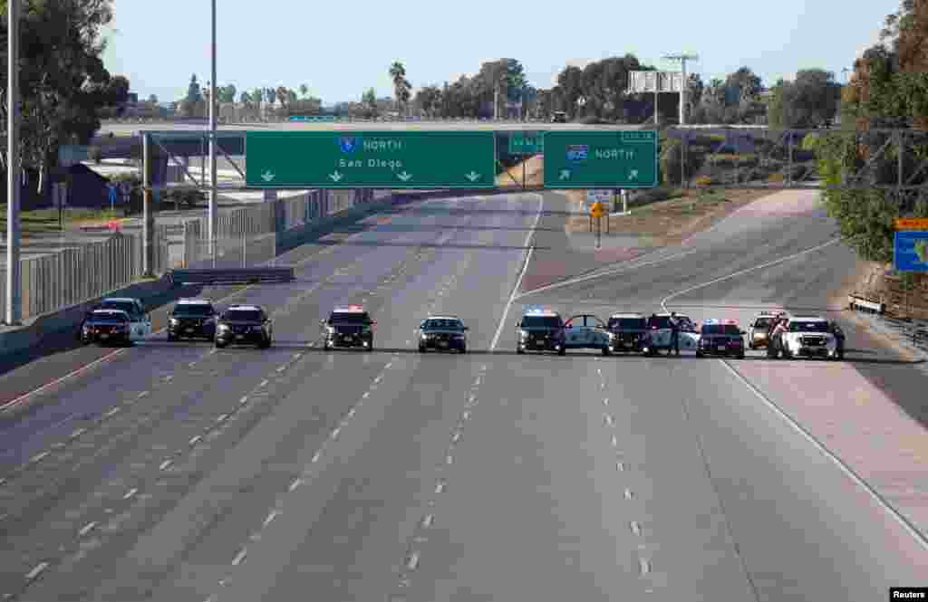 California Highway Patrol police cars block the highway leading from Mexico into San Diego, California, Nov. 25, 2018.