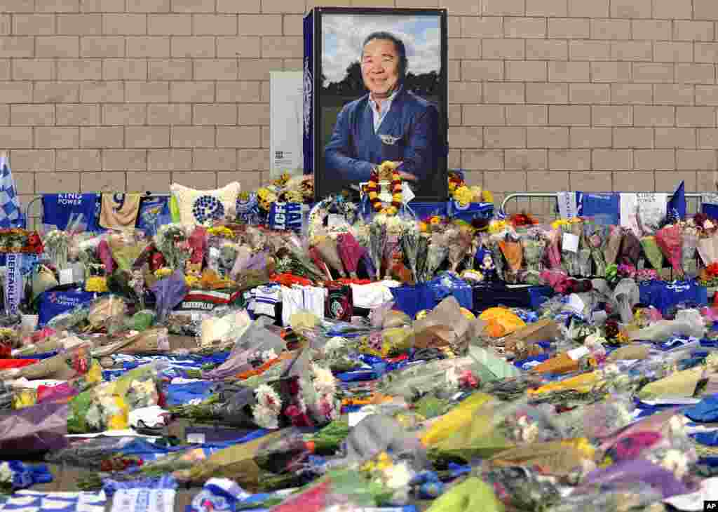 Tributes from supporters are seen outside Leicester City Football Club after a helicopter crashed Saturday killing Leicester City's owner, Thai billionaire Vichai Srivaddhanaprabha, and four other people, in Leicester, England,