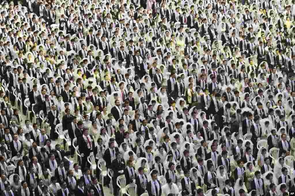 Couples from around the world participate in a mass wedding ceremony at the Cheong Shim Peace World Center in Gapyeong, South Korea. 3,800 couples from more than fifty countries exchanged or reaffirmed marriage vows in the Unification Church&#39;s mass wedding.