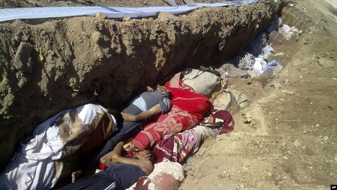This citizen journalism image provided by Shaam News Network SNN, taken on Sunday, Aug. 26, 2012, purports to show people killed by shabiha, pro-government militiamen, being buried in a mass grave in Daraya, Syria. According to activists' accounts, govern