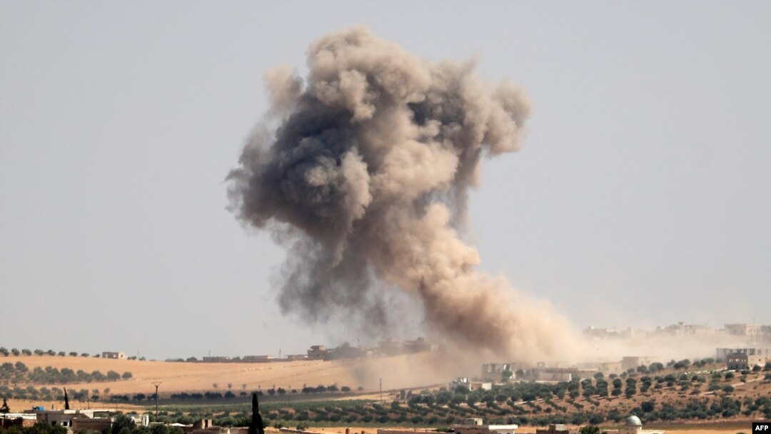Smoke billows during pro-regime bombardments in the area of Maar Hitat in Syria's northern Idlib province, Aug. 20, 2019.