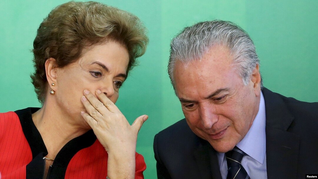 FILE - Brazil's President Dilma Rousseff (L) talks to Vice President Michel Temer at the Planalto Palace in Brasilia, Brazil, March 2, 2016.
