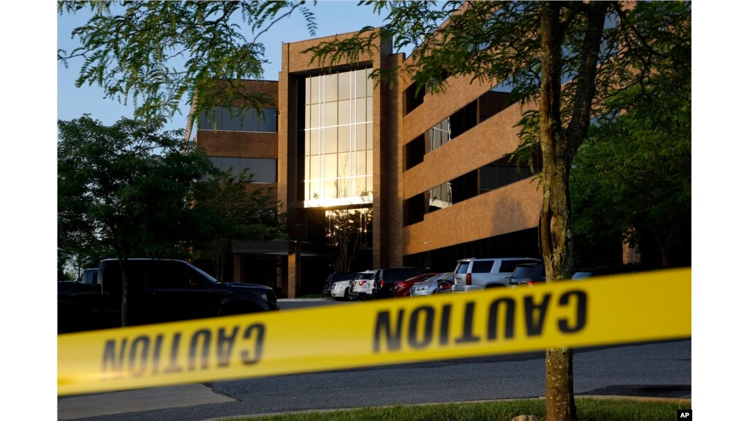 Crime scene tape surrounds a building housing The Capital Gazette newspaper's offices, Friday, June 29, 2018, in Annapolis, Md.
