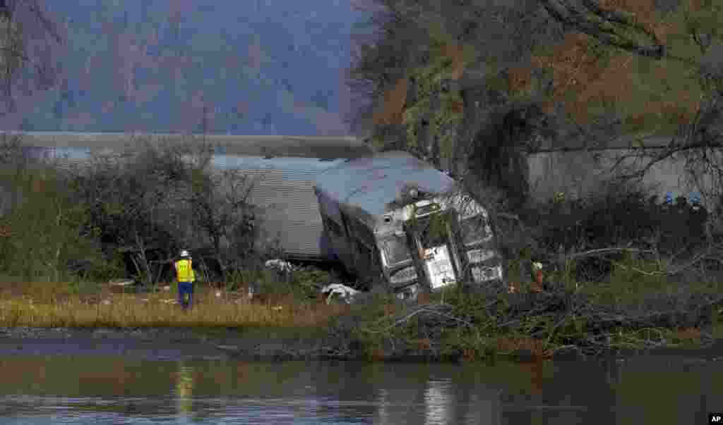 Viewed from Manhattan, a Metro-North passenger train rests off the tracks after derailing in the Bronx borough of New York, Dec. 1, 2013.