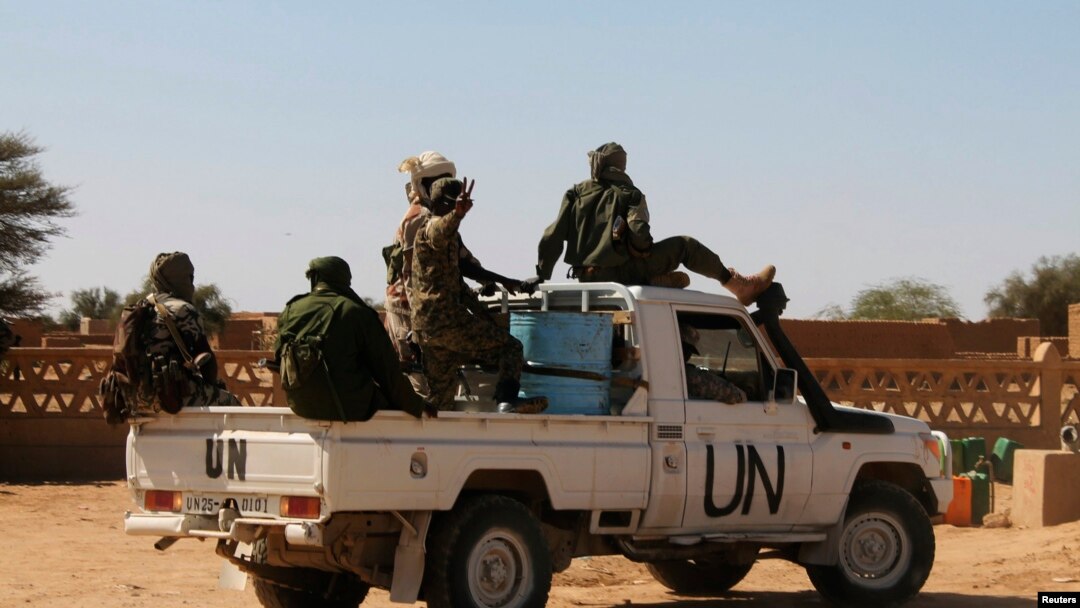FILE - Chadian U.N. peacekeepers gesture as they patrol in Aguelhok, Mali, Jan. 24, 2014.