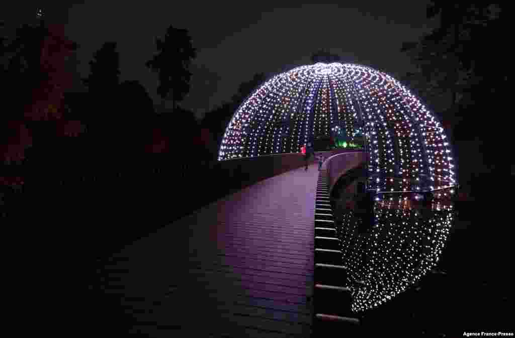 Lights illuminate the Sackler Crossing during a photocall at Kew Gardens in south west London, to preview the &quot;Christmas at Kew&quot; light show event.