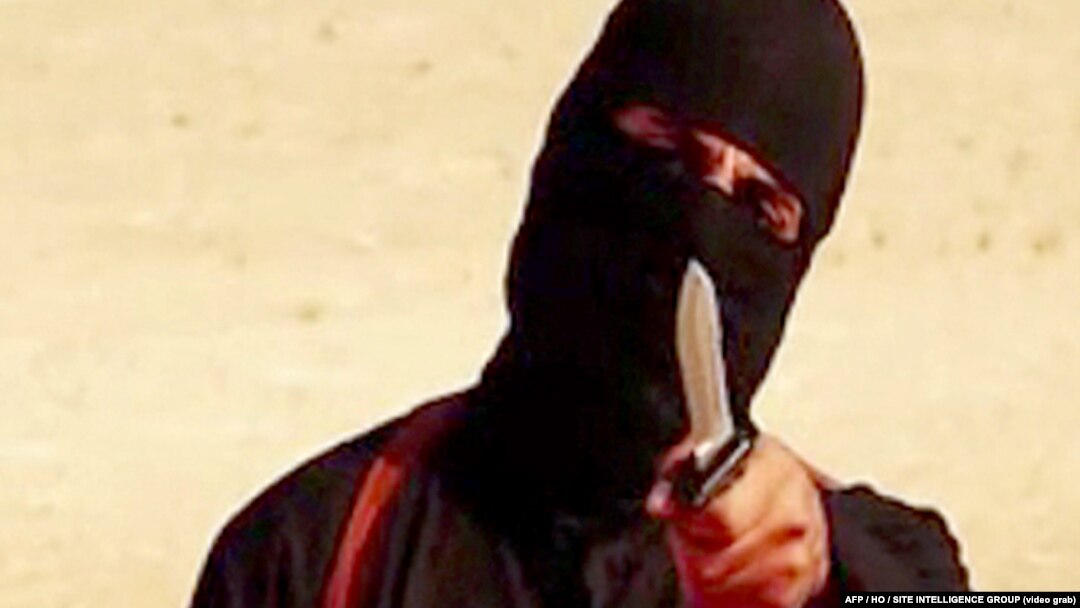 FILE - An image taken from a video released by the Islamic State group purportedly shows a masked militant holding a knife and gesturing as he speaks to the camera before beheading U.S. freelance writer Steven Sotloff. 
