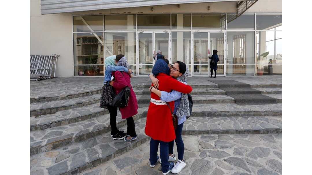 Students of American University of Afghanistan greet each other as they arrive for orientation sessions at American University in Kabul, March 27, 2017.